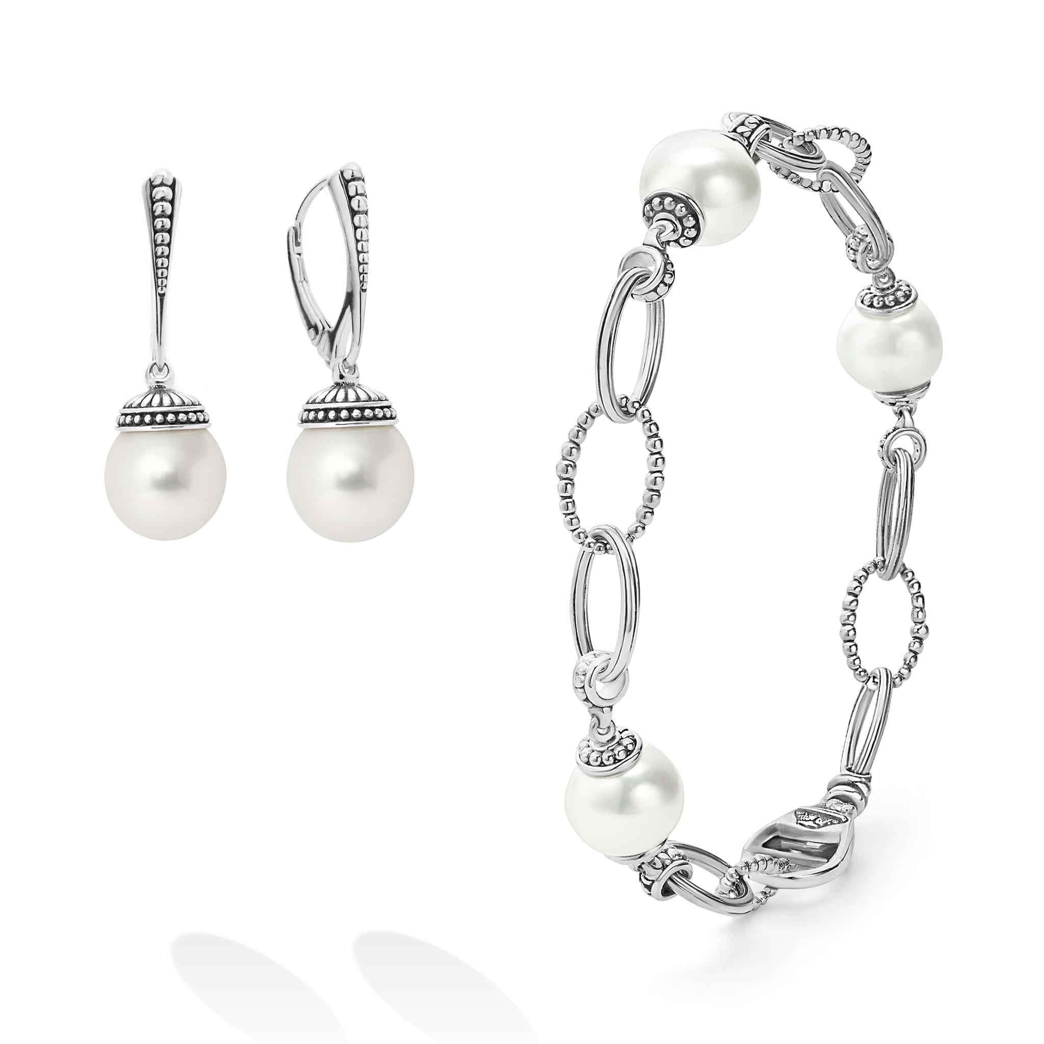 An ideal gift including sophisticated cultured freshwater pearl earrings framed by flutes of sterling silver and an 18 inch cultured freshwater pearl bracelet finished on a signature lobster clasp.