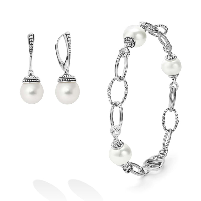 An ideal gift including sophisticated cultured freshwater pearl earrings framed by flutes of sterling silver and an 18 inch cultured freshwater pearl bracelet finished on a signature lobster clasp.