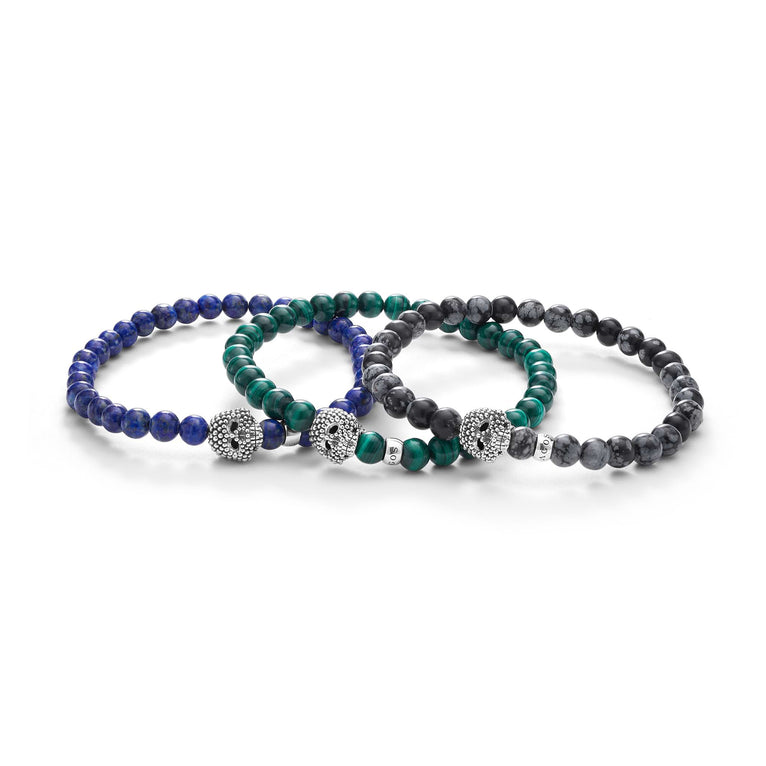 A LAGOS exclusive. Malachite, lapis, and snowflake obsidian gemstone bracelets accented by a sterling silver Caviar beaded skull.
