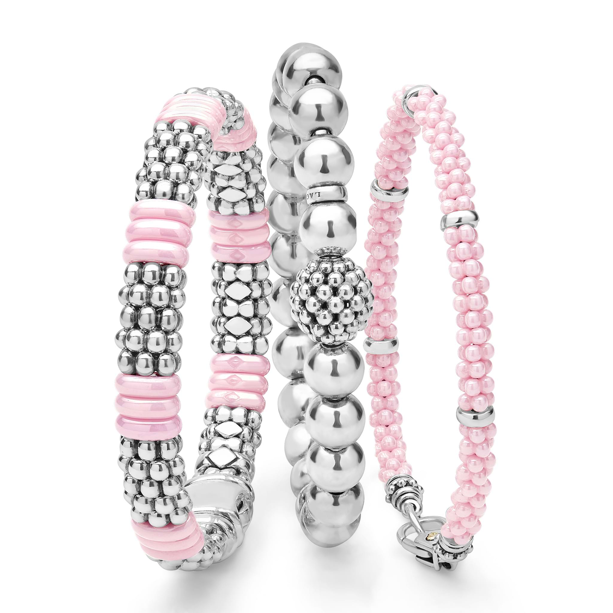 A LAGOS exclusive. Three classic bracelets to layer and make your own. One stretch bracelet made of smooth sterling silver. One pink ceramic Caviar beaded bracelet with sterling silver stations. One sterling silver Caviar beaded bracelet with a pop o
