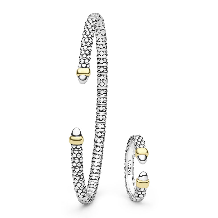 Silver and gold bracelet with matching ring on a white background