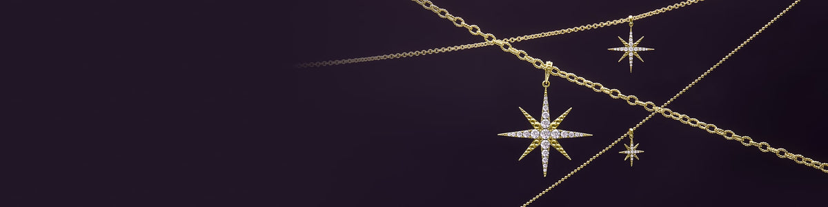 Dark purple background with three necklace chains with North Star diamond pendants