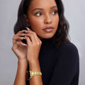 Young woman wearing the Smart Caviar 18K Gold Watch Bracelet-42-49mm, showcasing its chunky gold links on her wrist, paired with a matching beaded bracelet-style band.