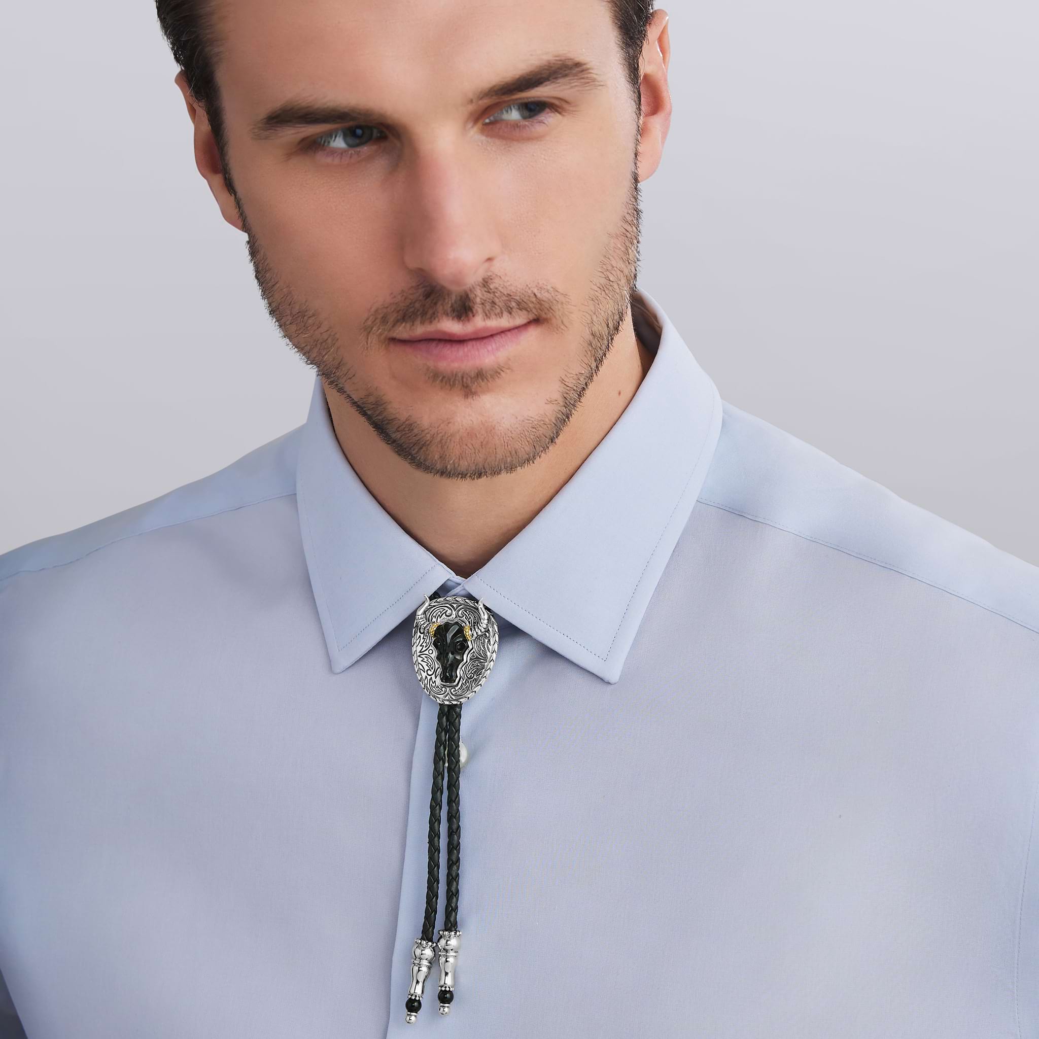 Man wearing Black Agate Tag Amulet Bolo, featuring black agate accented by sterling silver Caviar beading