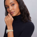 Young woman with a smartwatch featuring the Smart Caviar 18K Gold and Sterling Silver Watch Bracelet, showcasing elegant gold links and silver beads.