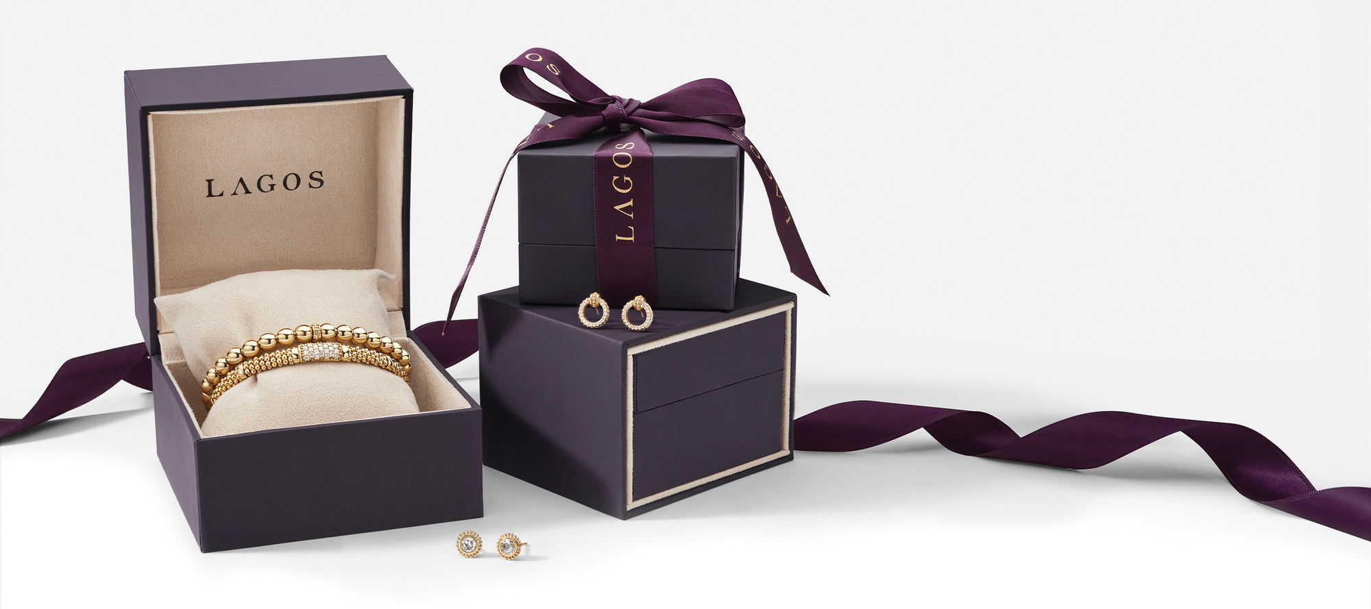 Three gift boxes with gold jewelry items