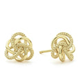 Love knot stud earrings formed of Caviar beaded and highly polished 18K gold bands.