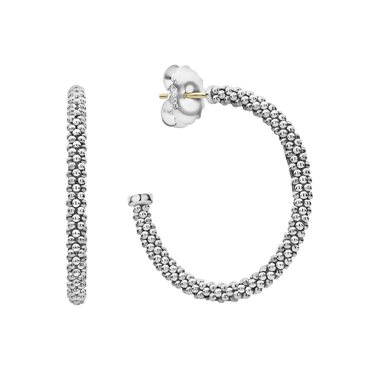 Signature sterling silver Caviar beads form these classic hoop earrings.