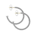 Signature Caviar Small Caviar Hoop Earrings featuring sterling silver caviar beading, with 14K gold posts and butterfly backs, showcasing timeless elegance for daily wear.