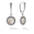 Mother of pearl gemstone circle drop earrings framed by Caviar beading.