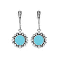 Maya Small Ceramic Circle Drop Earrings with turquoise stones in sterling silver bezels, surrounded by Caviar beading, and secured with lever back closures.
