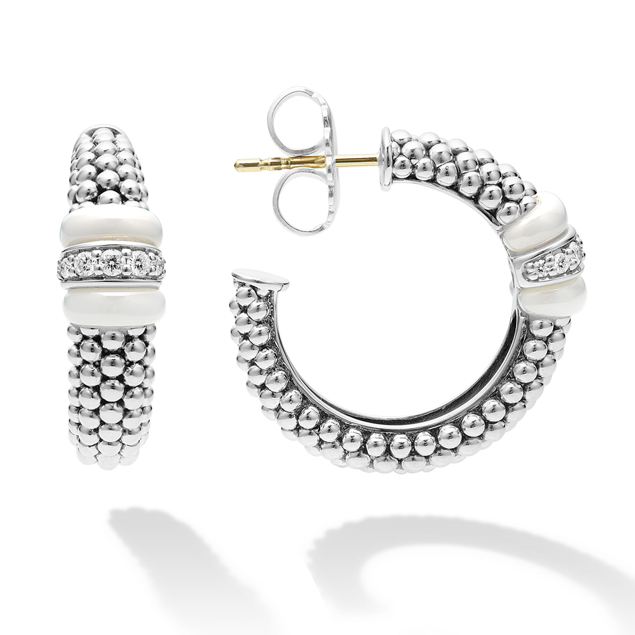 White ceramic and a diamond station highlight these sterling silver Caviar beaded hoop earrings. LAGOS diamonds are the highest quality natural stones.