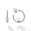 A beautiful pearl sits in the center of this sterling silver Caviar beaded hoop.