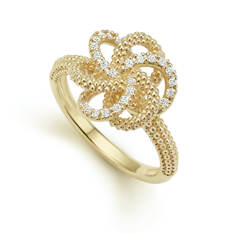 Diamond bands with Caviar beading form this 18K gold love knot ring. LAGOS diamonds are the highest quality natural stones.