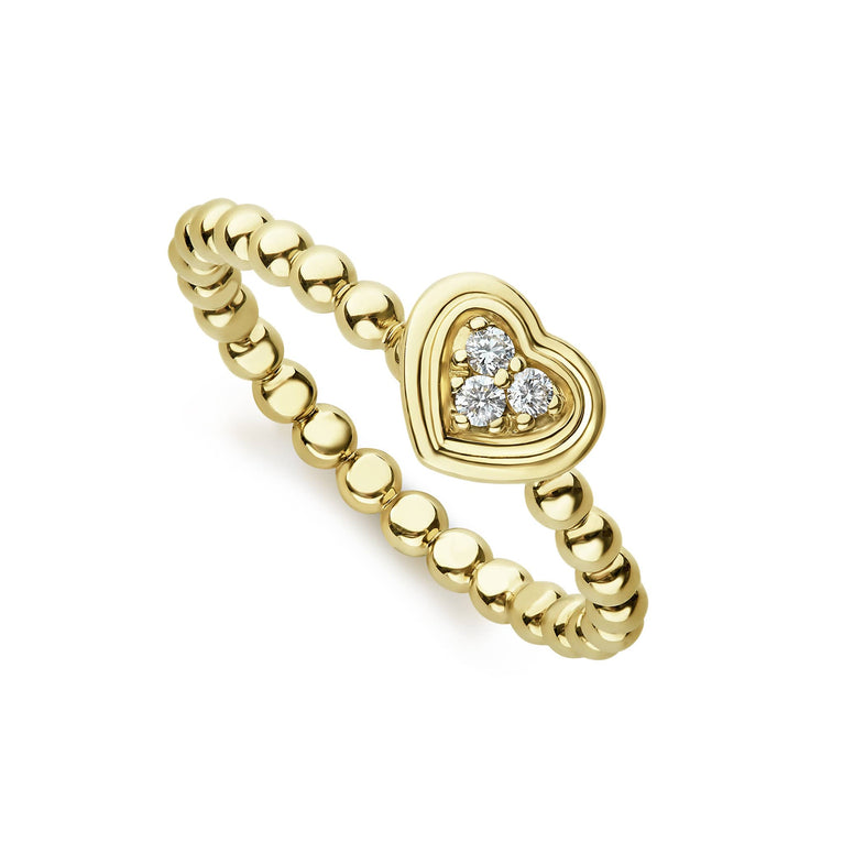 A diamond surrounded by a heart forms this 18K gold ring finished on a band of Caviar beading. LAGOS diamonds are the highest quality natural stones.