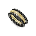 Three stacking rings form this set with two black ceramic beaded rings and one 18K gold ring.