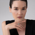 Woman wearing a Rare Wonders Turquoise Beetle Diamond Ring with an 18K gold and sterling silver beetle-shaped mount on her finger.