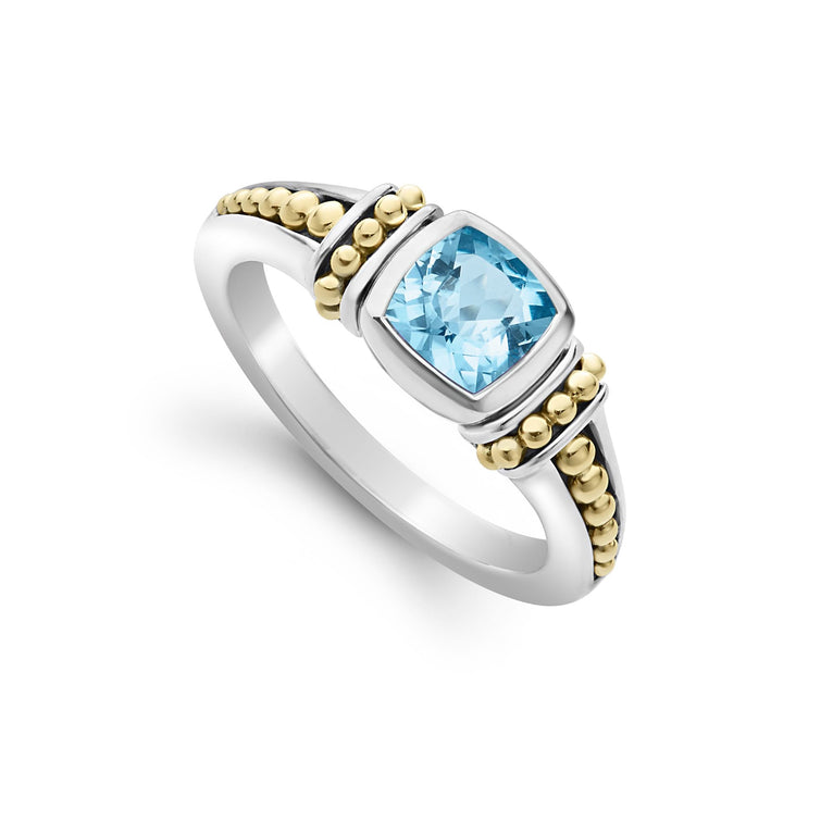 Swiss blue topaz gemstone ring surrounded by sterling silver and 18K gold Caviar beading.