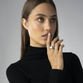 Woman models the Black Caviar Black Three Station Ceramic Caviar Diamond Ring, showcasing its sterling silver, diamond rows, and caviar beading.