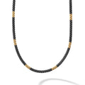 Twelve 18K gold stations highlighted by black ceramic Caviar beading on this necklace finished with an 18K gold lobster clasp.