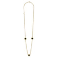 Three round onyx stations set and surrounded by 18K gold Caviar beading on this necklace.
