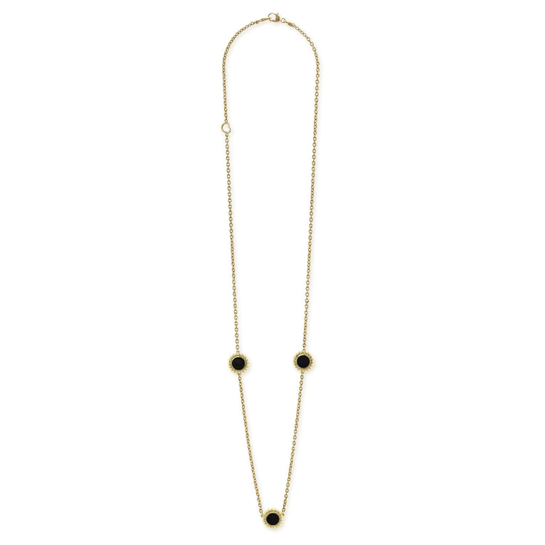 Three round onyx stations set and surrounded by 18K gold Caviar beading on this necklace.