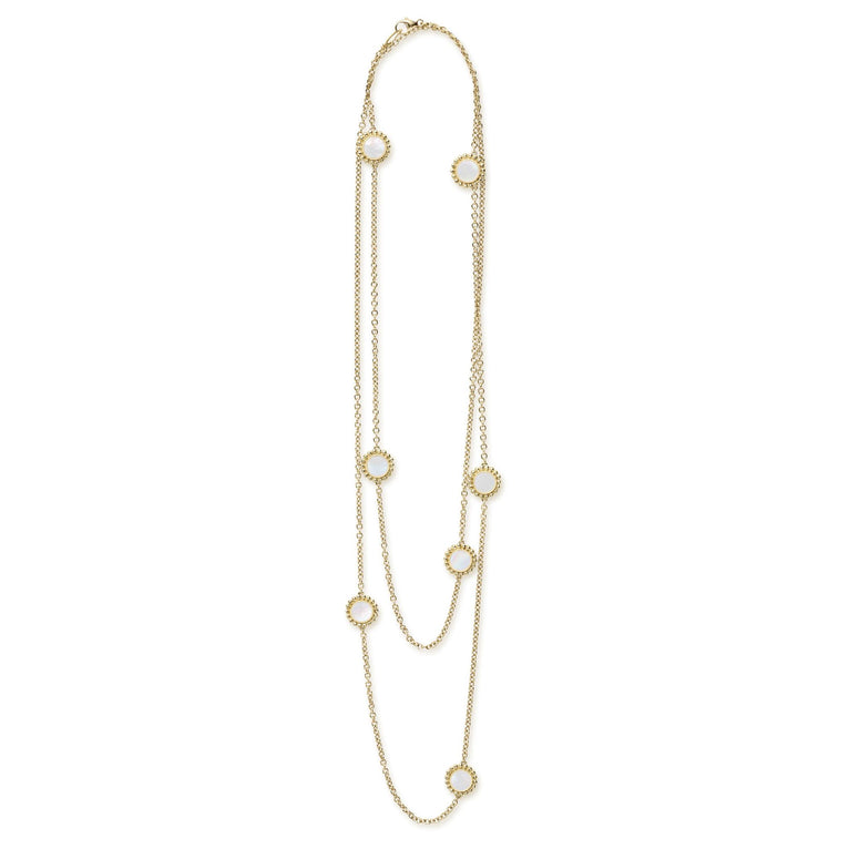 Seven round Mother of Pearl stations set and surrounded by 18K gold Caviar beading on this necklace.