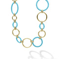 A modern necklace with 18K gold and blue ceramic round, oval and beaded links.