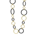 A modern necklace with 18K gold and black ceramic round, oval and beaded links.
