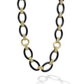 A classic necklace with 18K gold and black ceramic oval and beaded links.