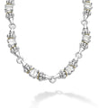 Ten emerald-cut white topaz gemstones with a prong setting in sterling silver and 18K gold Caviar beading form this necklace.
