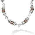 Ten emerald-cut smokey quartz gemstones with a prong setting in sterling silver and 18K gold Caviar beading form this necklace.