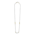 Beloved Oval Plate Necklace featuring a sterling silver ball-chain design, accented with 18K gold caviar beading and a polished ID-tag pendant.