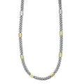 Ten smooth stations of 18K gold and sterling silver surrounded by Caviar beading.