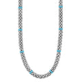A sterling silver Caviar beaded necklace with 14 blue ceramic stations.