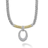 Pavé diamonds form this oval pendant that is finished on a signature sterling silver Caviar necklace with 18k gold accents. LAGOS diamonds are the highest quality natural stones.