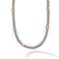 Six smooth stations of 18K rose gold and sterling silver surrounded by Caviar beading form this necklace.
