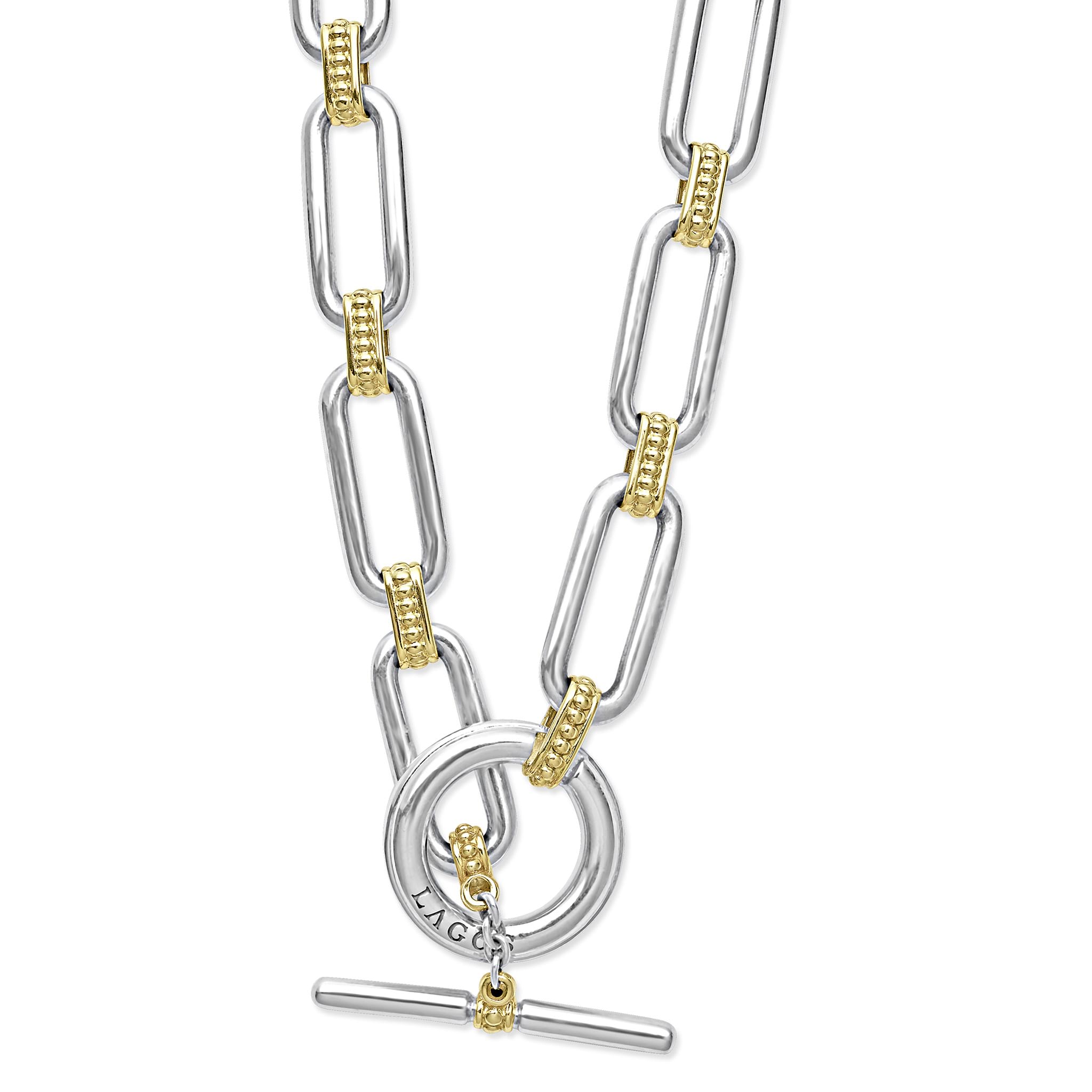 Signature Caviar Two-Tone Link Necklace in sterling silver and 18K gold, featuring elongated links with caviar beading and a toggle-bar clasp stamped “LAGOS.”