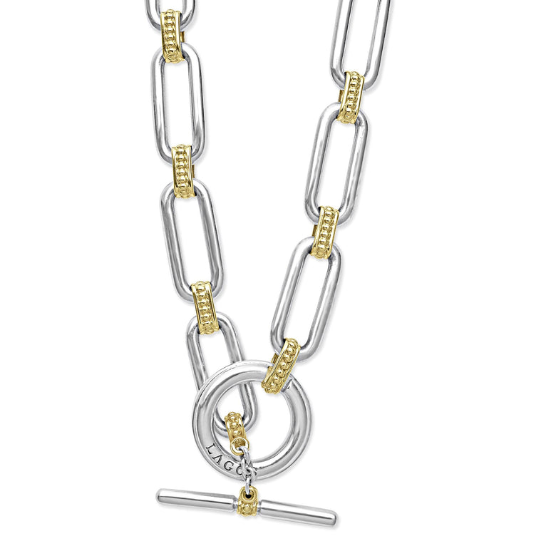 Signature Caviar Two-Tone Link Necklace in sterling silver and 18K gold, featuring elongated links with caviar beading and a toggle-bar clasp stamped “LAGOS.”