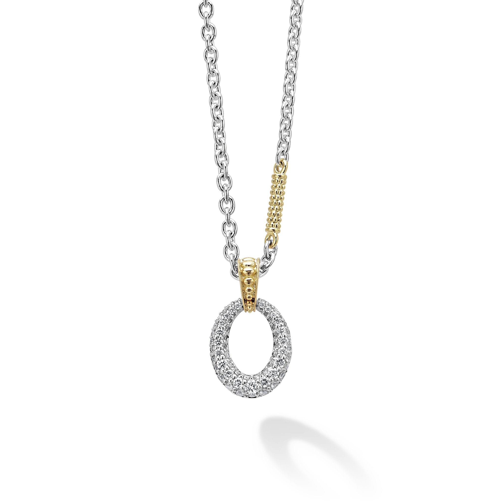 Pavé diamonds form this oval pendant that is finished on a signature sterling silver Caviar necklace with 18k gold accents. LAGOS diamonds are the highest quality natural stones.