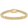An 18K gold Caviar beaded bracelet with smooth stations.