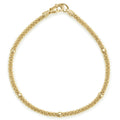 An 18K gold Caviar beaded bracelet with five smooth stations.