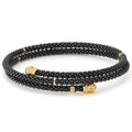 Classic black ceramic Caviar beading finished with 18k gold endcaps form this coil bracelet.