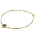 Covet Single Station Round Onyx Bracelet featuring an 18K gold chain with a black onyx charm, caviar beading, and a heart link near the clasp.