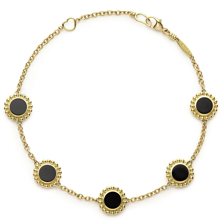 An 18k gold bracelet including five onyx inlay stations with Caviar beaded details.