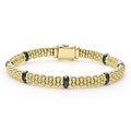 Seven smooth black ceramic stations highlight 18k gold Caviar beading on this signature bracelet.
