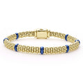 Seven smooth ultramarine ceramic stations highlight 18k gold Caviar beading on this signature bracelet.