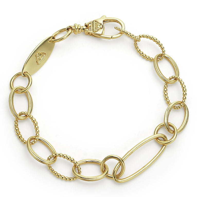 18k gold variations of smooth elements form this timeless link bracelet.
