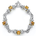 Five citrine emerald-cut gemstones, with 18k gold and sterling silver detailing form this bracelet.