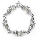 Five white topaz emerald-cut gemstones, with 18k gold and sterling silver detailing form this bracelet.